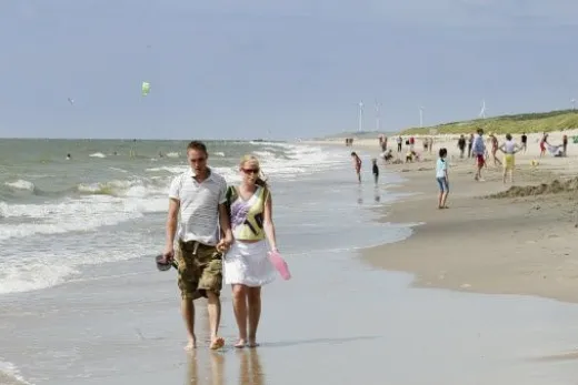 Mensen wandelen over het strand